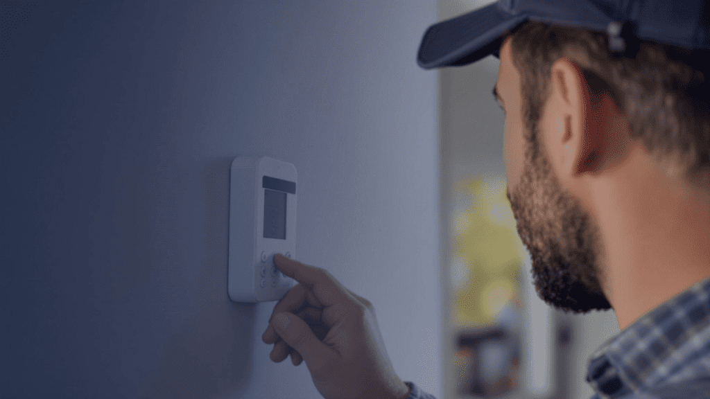 HVAC tech testing new thermostat installation